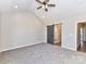 Spacious bedroom with en-suite bathroom features modern ceiling fan and a barn door at 2328 Kingsburry Rd, York, SC 29745