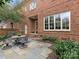 Beautiful brick home featuring a cozy patio and lush landscaping, ideal for outdoor living at 261 Crownsgate Ct, Charlotte, NC 28207