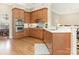 Spacious kitchen with stainless steel appliances, wood cabinets, and eat-in bar at 261 Crownsgate Ct, Charlotte, NC 28207