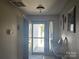 Inviting entryway with bright lighting and a 'God Bless Our Home' sign on the door at 2630 Sloan Dr, Charlotte, NC 28208