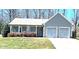 Charming single-story home with an attached two-car garage and a well-manicured front lawn at 2630 Sloan Dr, Charlotte, NC 28208
