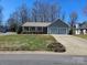 Charming single-story home featuring a two-car garage and a welcoming front porch, complemented by a landscaped lawn at 2630 Sloan Dr, Charlotte, NC 28208