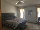 Comfortable bedroom featuring a large bed, soft carpet, and natural lighting from the large windows at 2630 Sloan Dr, Charlotte, NC 28208