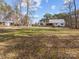 Expansive backyard featuring a well-maintained lawn, mature trees, and a charming home exterior at 265 River Run Rd, Statesville, NC 28625