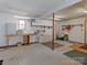 A basement with shelving, cabinets and worktable offers opportunity for customization and utilitarian function at 265 River Run Rd, Statesville, NC 28625