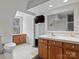 Bright bathroom featuring wood cabinets, tiled floors and walls, and a built in vanity at 265 River Run Rd, Statesville, NC 28625