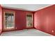 Bedroom with red walls, carpet, and two windows with wooded views at 265 River Run Rd, Statesville, NC 28625