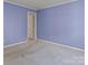 A simply decorated bedroom with light purple walls and neutral carpet offers a calm, inviting space at 265 River Run Rd, Statesville, NC 28625