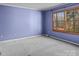 Bright bedroom with a large window overlooking a lush outdoor scene, creating a tranquil retreat at 265 River Run Rd, Statesville, NC 28625