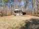 Charming cabin with a cozy front porch, set amidst a serene natural setting on a lush lot at 265 River Run Rd, Statesville, NC 28625