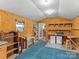 Cozy interior with wood paneling, functional workspaces, and storage solutions at 265 River Run Rd, Statesville, NC 28625