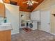 Laundry room with washer, dryer, sink and a unique ceiling fan, exuding functionality and vintage charm at 265 River Run Rd, Statesville, NC 28625