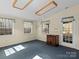 Bright living room with natural light from the windows, blue carpet, and wood accents on ceiling at 265 River Run Rd, Statesville, NC 28625