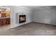 Comfortable living room with cozy fireplace and views into the adjacent kitchen at 265 River Run Rd, Statesville, NC 28625