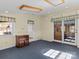 Bright living room with blue carpet, wood accents, and natural light from the windows and glass doors at 265 River Run Rd, Statesville, NC 28625