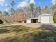 Property with spacious outbuildings and ample parking space on a well-maintained lawn at 265 River Run Rd, Statesville, NC 28625