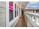 Long balcony with a white railing and several large windows at 2719 Selwyn Ave # 6, Charlotte, NC 28209