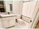 A bathroom featuring a granite vanity, neutral tile, and a tub with a gray striped shower curtain at 2719 Selwyn Ave # 6, Charlotte, NC 28209