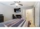 Well-lit bedroom with a relaxing atmosphere, including a ceiling fan, desk, and neutral walls at 2719 Selwyn Ave # 6, Charlotte, NC 28209