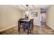Dining area with modern light fixture located near the kitchen with hardwood style floors at 2719 Selwyn Ave # 6, Charlotte, NC 28209