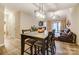 Cozy dining area with a modern light fixture adjacent to living area with lots of light at 2719 Selwyn Ave # 6, Charlotte, NC 28209