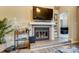 Living room featuring a fireplace, TV, and bar area on hardwood style floors at 2719 Selwyn Ave # 6, Charlotte, NC 28209