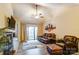 Inviting living room featuring a leather couch, fan, fireplace, and access to the outdoors at 2719 Selwyn Ave # 6, Charlotte, NC 28209