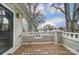 View of the surrounding neighborhood from the charming front porch featuring a railing and plenty of space to relax at 2719 Selwyn Ave # 6, Charlotte, NC 28209