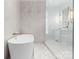 An elegant bathroom displays a soaking tub, glass-enclosed shower, and sleek white vanity at 2818 Kenwood Sharon Ln, Charlotte, NC 28211