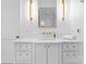 Modern bathroom featuring white cabinetry, gold hardware, and a stylish mirror at 2818 Kenwood Sharon Ln, Charlotte, NC 28211