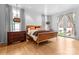 Primary bedroom featuring hardwood floors, a walkout patio, and modern light fixtures at 2818 Kenwood Sharon Ln, Charlotte, NC 28211