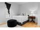 Simple bedroom featuring a comfortable bed, soft lighting, and modern decor at 2818 Kenwood Sharon Ln, Charlotte, NC 28211