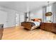 Bedroom with hardwood floors, stylish light fixtures, and ensuite bathroom at 2818 Kenwood Sharon Ln, Charlotte, NC 28211