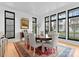 Elegant dining room with large windows, stylish chairs, and a vibrant area rug at 2818 Kenwood Sharon Ln, Charlotte, NC 28211