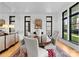 Chic dining room with a modern table, gray upholstered chairs, and ample natural light at 2818 Kenwood Sharon Ln, Charlotte, NC 28211