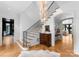 Grand foyer with a staircase, elegant chandelier, and herringbone wood floors at 2818 Kenwood Sharon Ln, Charlotte, NC 28211