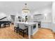 Bright, open kitchen with large island, hardwood floors, marble accents and grand piano nearby at 2818 Kenwood Sharon Ln, Charlotte, NC 28211