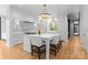 Bright, modern kitchen with a center island, white cabinets, and stainless steel appliances at 2818 Kenwood Sharon Ln, Charlotte, NC 28211