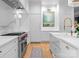 Bright kitchen featuring stainless steel appliances, marble countertops and backsplash, and hardwood floors at 2818 Kenwood Sharon Ln, Charlotte, NC 28211