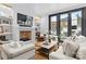 Comfortable living room with a fireplace, built-in shelving, and large windows to the backyard at 2818 Kenwood Sharon Ln, Charlotte, NC 28211