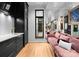 A stunning living room featuring a wet bar, mirrored wall, and plush pink sofa at 2818 Kenwood Sharon Ln, Charlotte, NC 28211