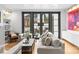 Bright living room with a fireplace, hardwood floors, and large windows to the backyard at 2818 Kenwood Sharon Ln, Charlotte, NC 28211