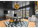 Contemporary home office featuring dark walls, a unique light fixture, and hardwood floors at 2818 Kenwood Sharon Ln, Charlotte, NC 28211