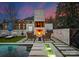 Inviting outdoor pool area with fireplace, lounge chairs, and lush landscaping, perfect for relaxation and entertaining at 2818 Kenwood Sharon Ln, Charlotte, NC 28211