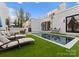 Stylish backyard featuring a modern pool, comfortable lounge seating, and lush greenery at 2818 Kenwood Sharon Ln, Charlotte, NC 28211