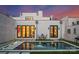 Luxurious backyard with a modern pool, manicured lawn, and outdoor seating under a vibrant evening sky at 2818 Kenwood Sharon Ln, Charlotte, NC 28211