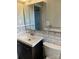 Bathroom featuring a dark wood vanity with white countertop and subway tile backsplash at 2921 Fort St, Charlotte, NC 28205