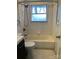 Bathroom featuring subway tile, a bathtub, and a shower at 2921 Fort St, Charlotte, NC 28205