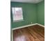 Bedroom featuring green walls, a window, and hardwood flooring at 2921 Fort St, Charlotte, NC 28205