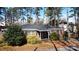 Charming brick ranch-style home with a covered front porch and mature landscaping at 2921 Fort St, Charlotte, NC 28205